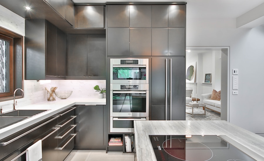 A modern kitchen with stainless steel appliances and marble countertops
